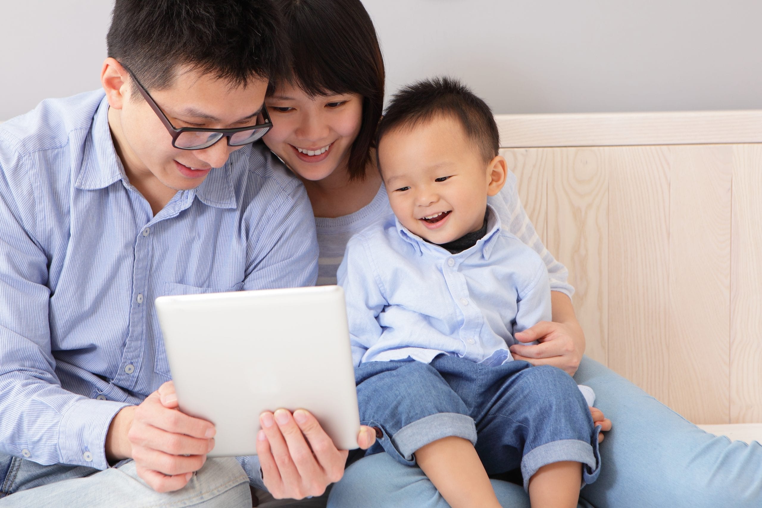 asian couple showing they happy baby an ipad