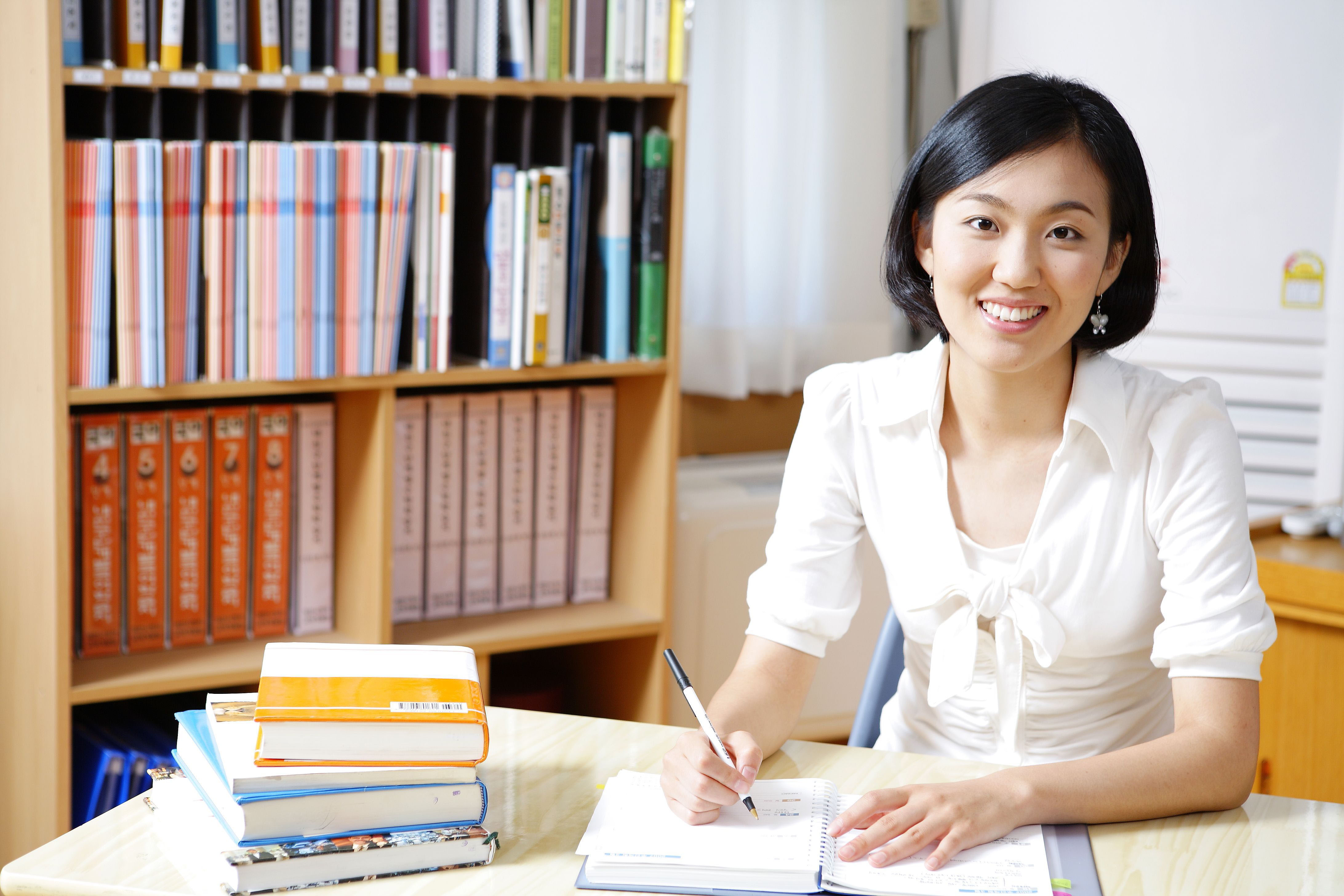 asian teacher preparing her lesson