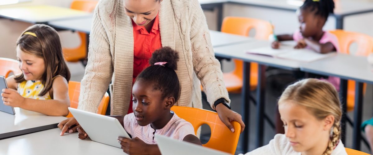 Teacher giving lesson to her students with technology 740686