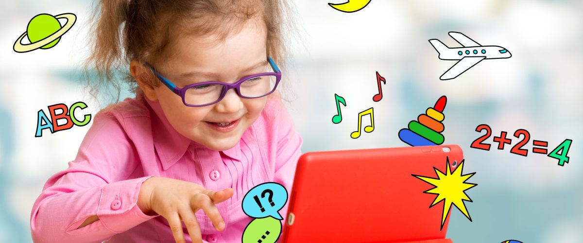 Child sitting with tablet computer and learning or playing with Child sitting with tablet computer and learning or playing with great interest
