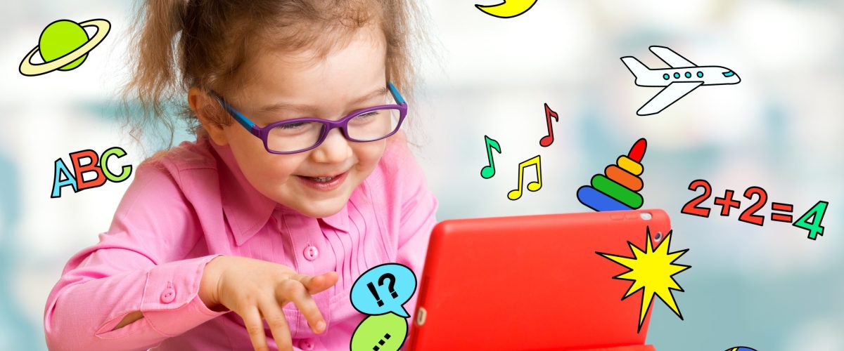 Child sitting with tablet computer and learning or playing with Child sitting with tablet computer and learning or playing with great interest